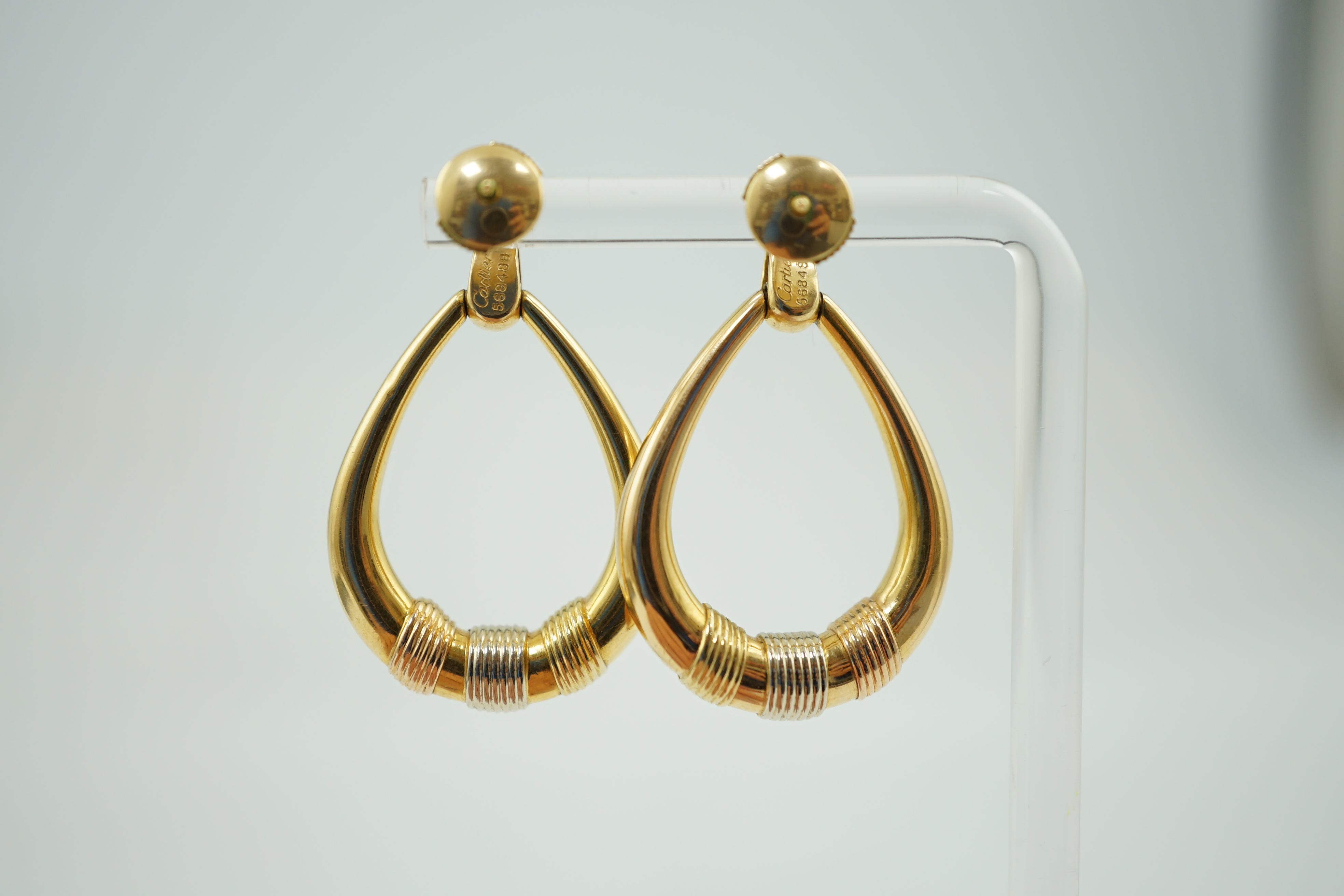 A modern pair of Cartier three colour 18k gold loop earrings